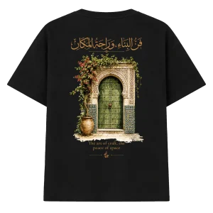 T-shirt oversize « Heritage » noir, vu de dos : grande illustration d’une porte verte à zellige entourée de fleurs, surmontée d’une calligraphie arabe
